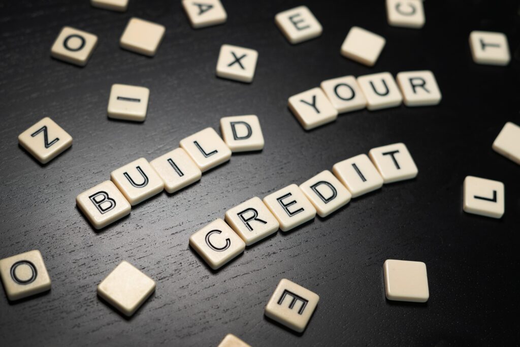 Tile letters spelling out “Build Your Credit” | How to build your credit score fast