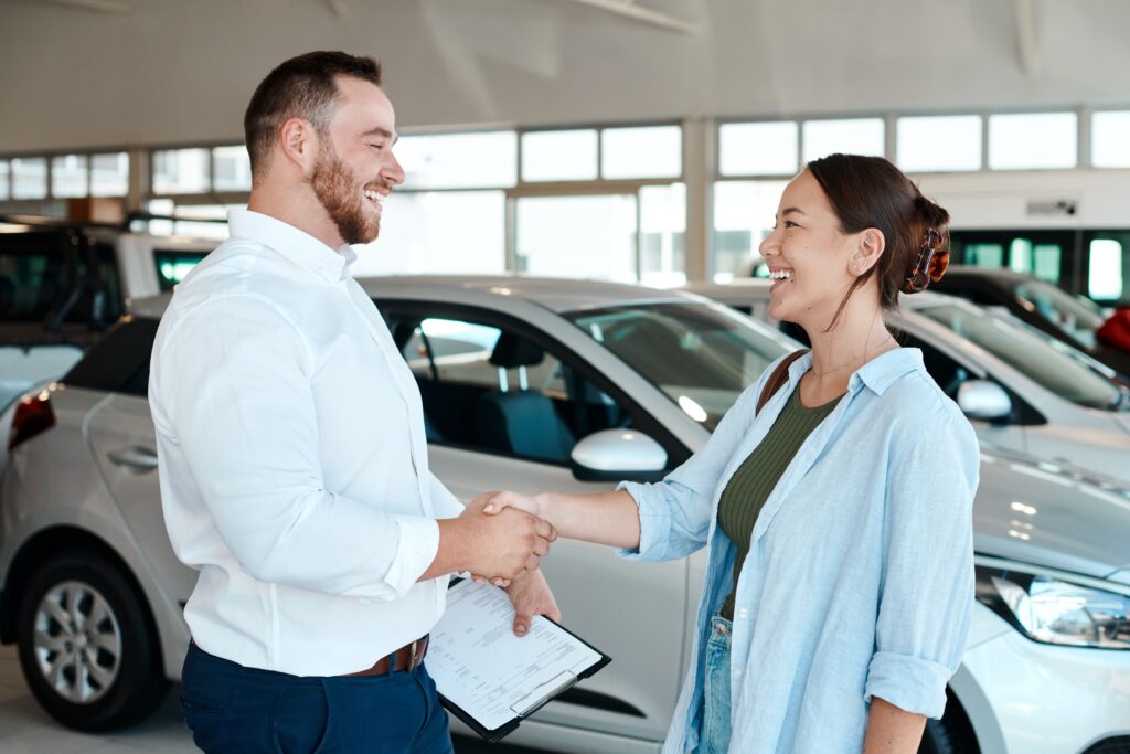  Handshake at car dealership | How to get a car loan with bad credit