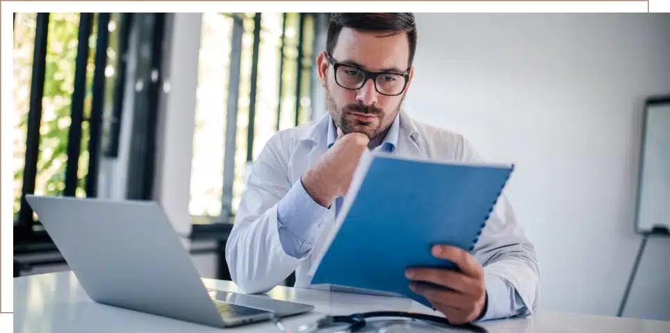 A doctor reviewing paperwork